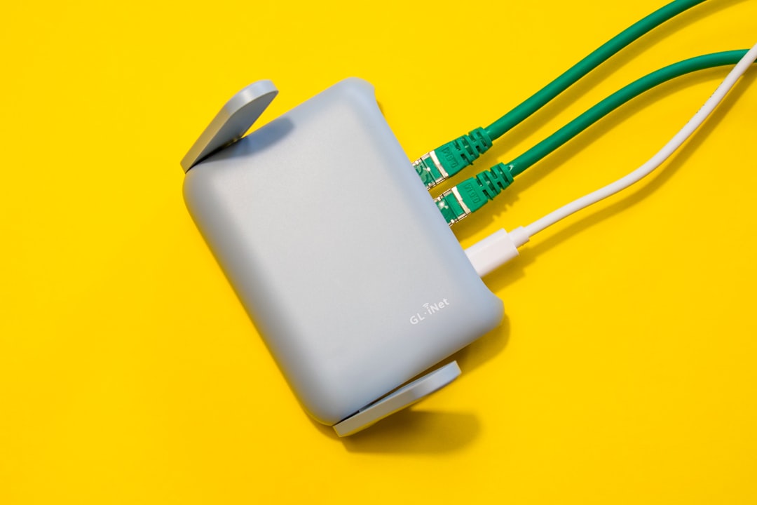 Router with cables plugged in, on yellow background.
